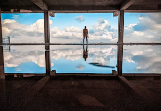 a man standing in front of a large window