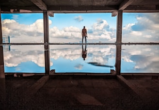 a man standing in front of a large window