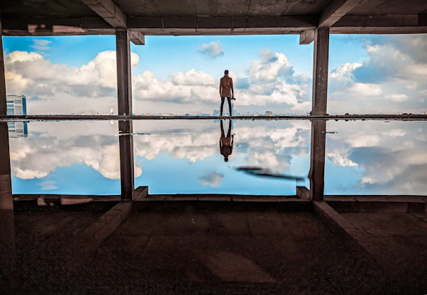 a man standing in front of a large window