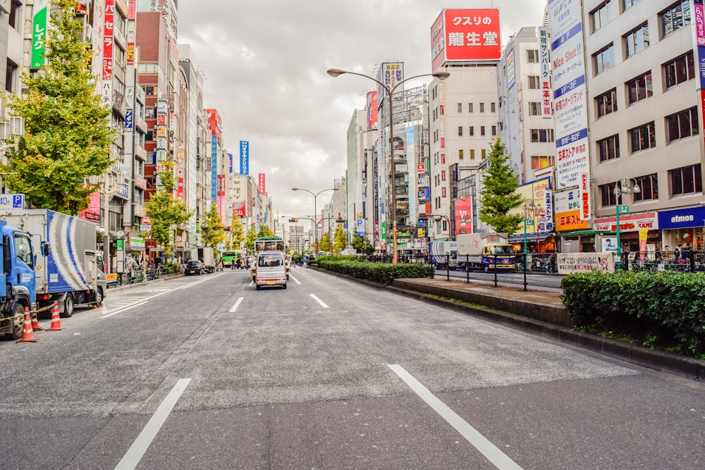 a city street lined with tall buildings and trees