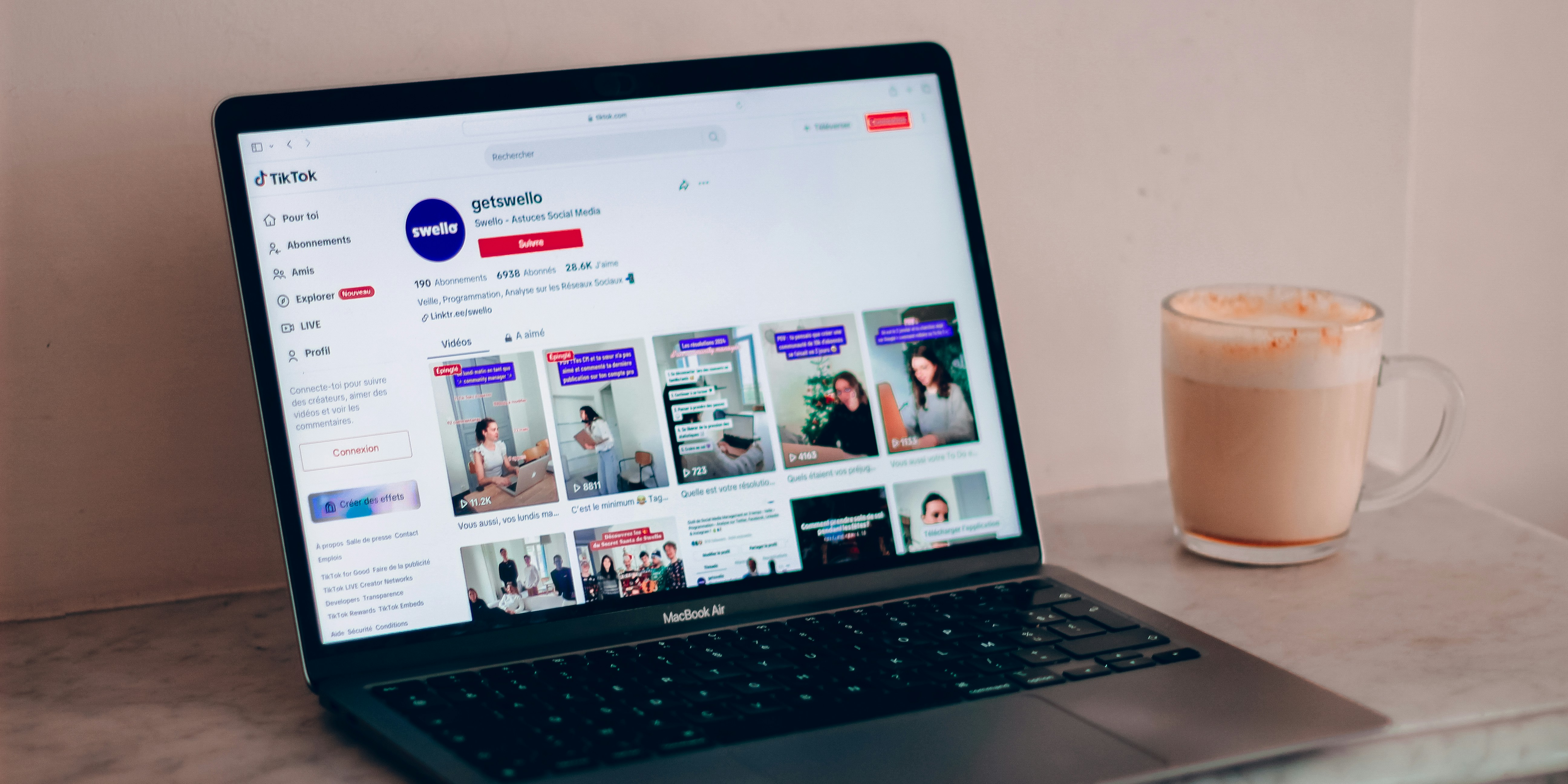 A laptop sits open to a page of TikTok videos, as the creator determines the difference between TikTok creator vs personal account.