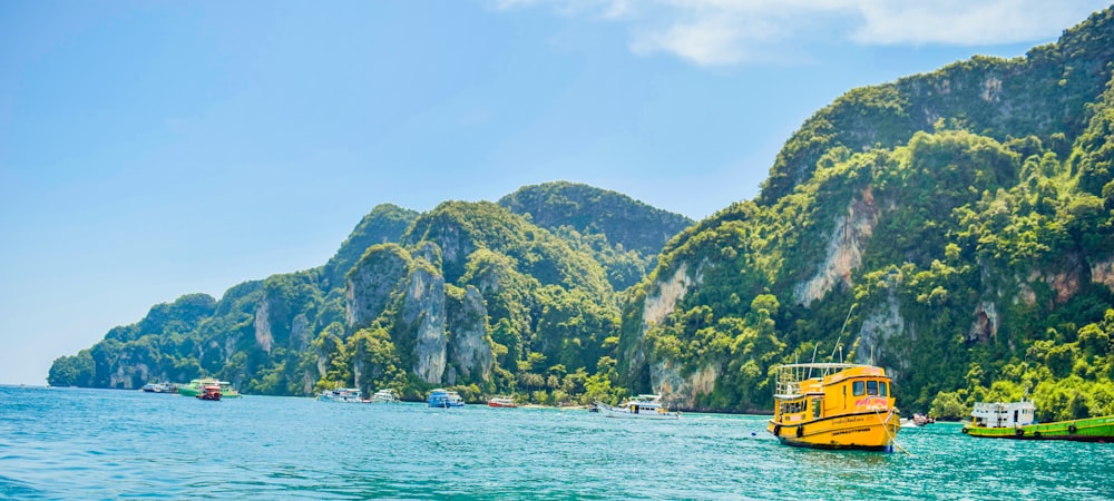 a yellow boat floating on top of a body of water