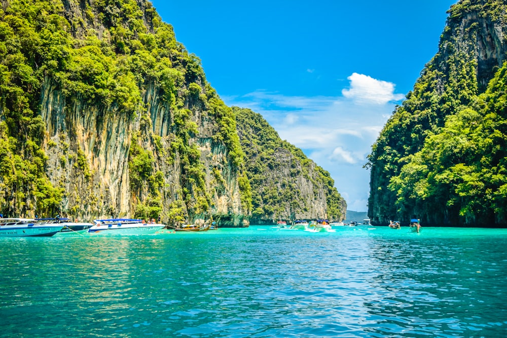 a group of boats floating on top of a body of water