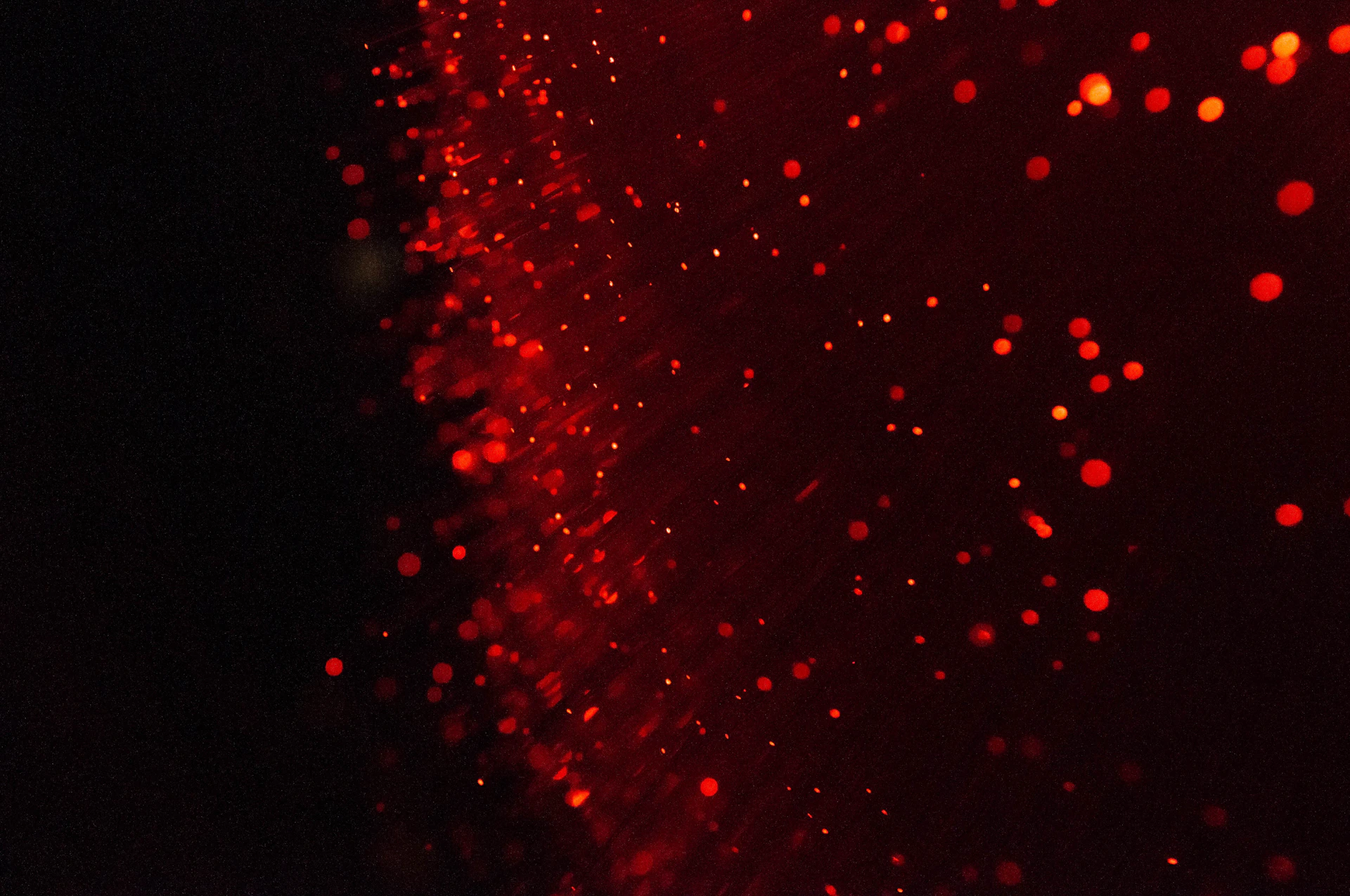 a blurry image of red lights on a black background
