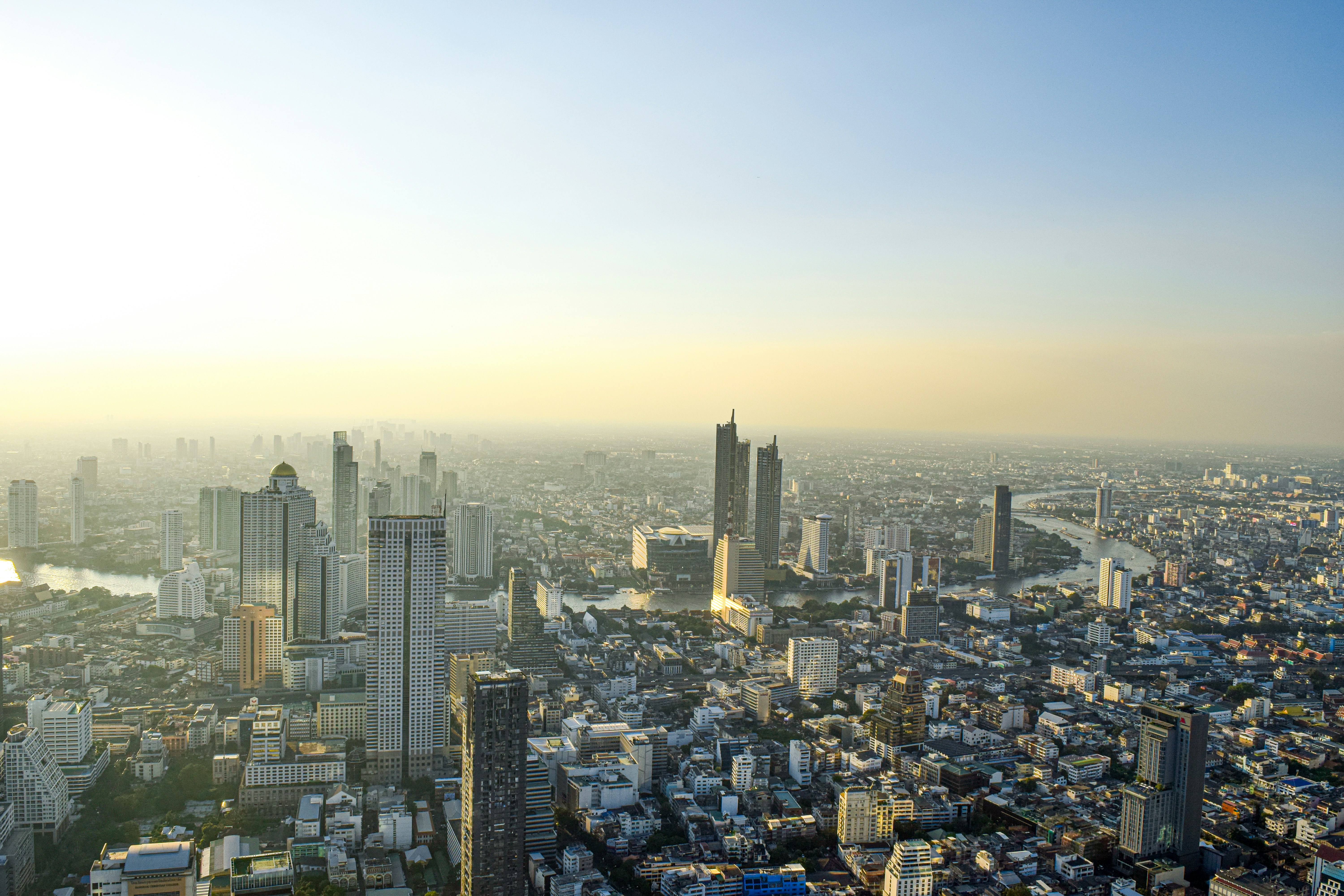 Tokyo city skyline at dawn with golden light reflecting on buildings and streets