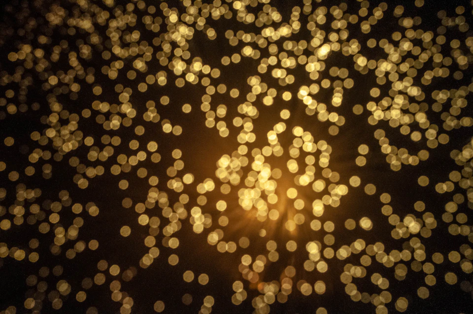 Close-up view of black background with numerous small colored circles in varying sizes