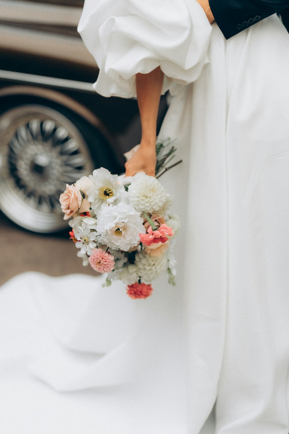 a woman in a white dress holding a bouquet of flowers