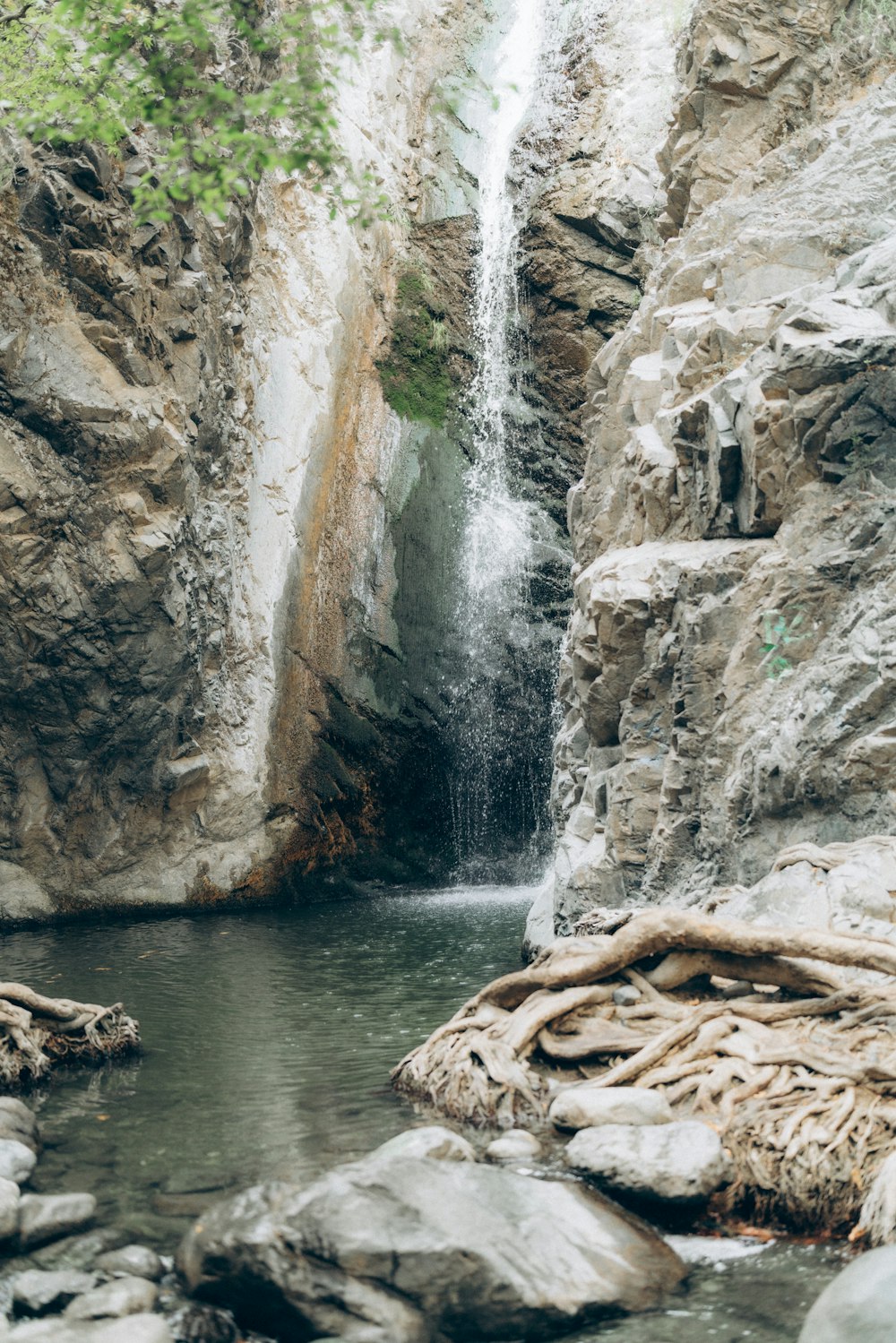 a small waterfall in the middle of a rocky area