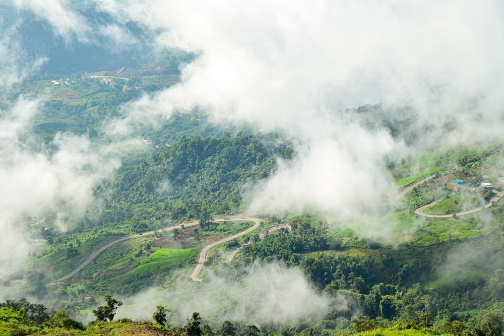 a scenic view of a winding road in the mountains