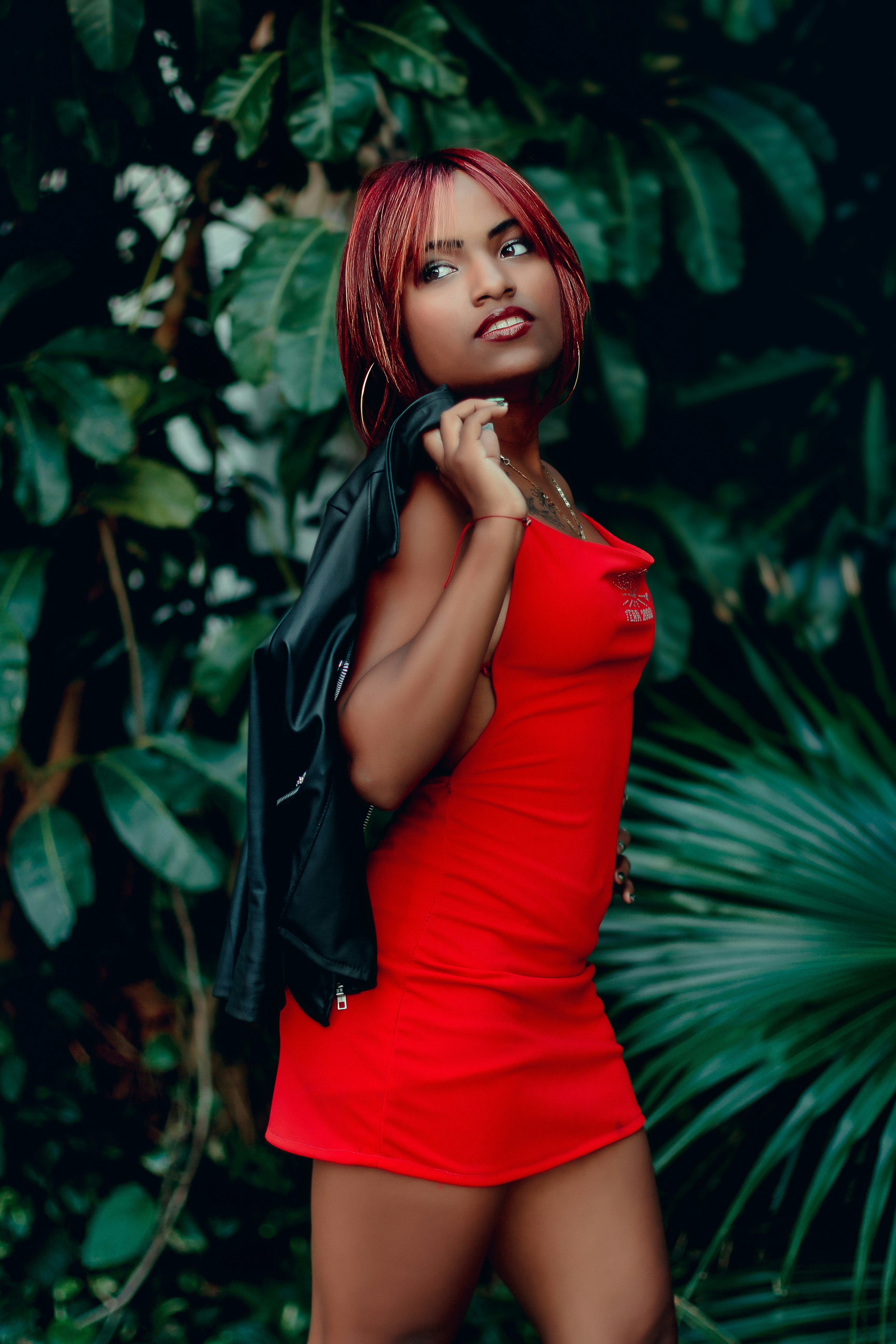 a woman in a red dress posing for a picture