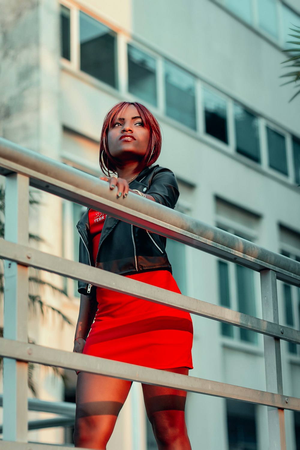 a woman in a red skirt and black jacket