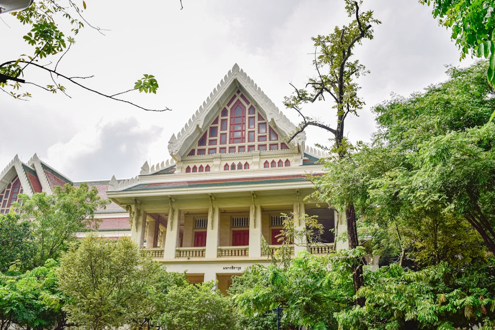 a white and red building surrounded by trees