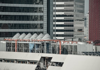 an airplane is flying over a city with tall buildings