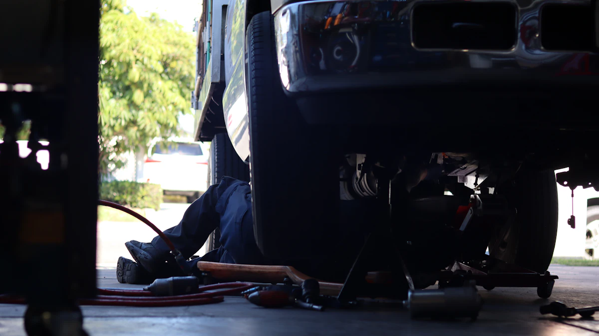 Technician working under a vehicle