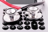 a stethoscope sitting on top of a calculator