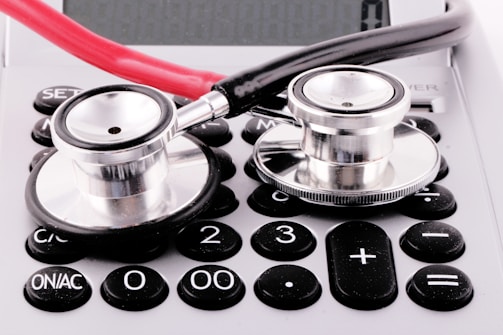 a stethoscope sitting on top of a calculator