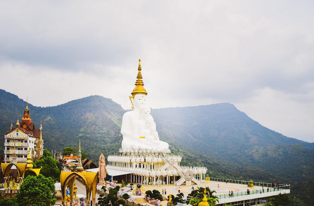 a large white building with a golden spire on top of it