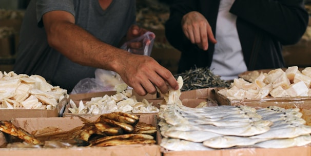 a man standing over a table filled with lots of food