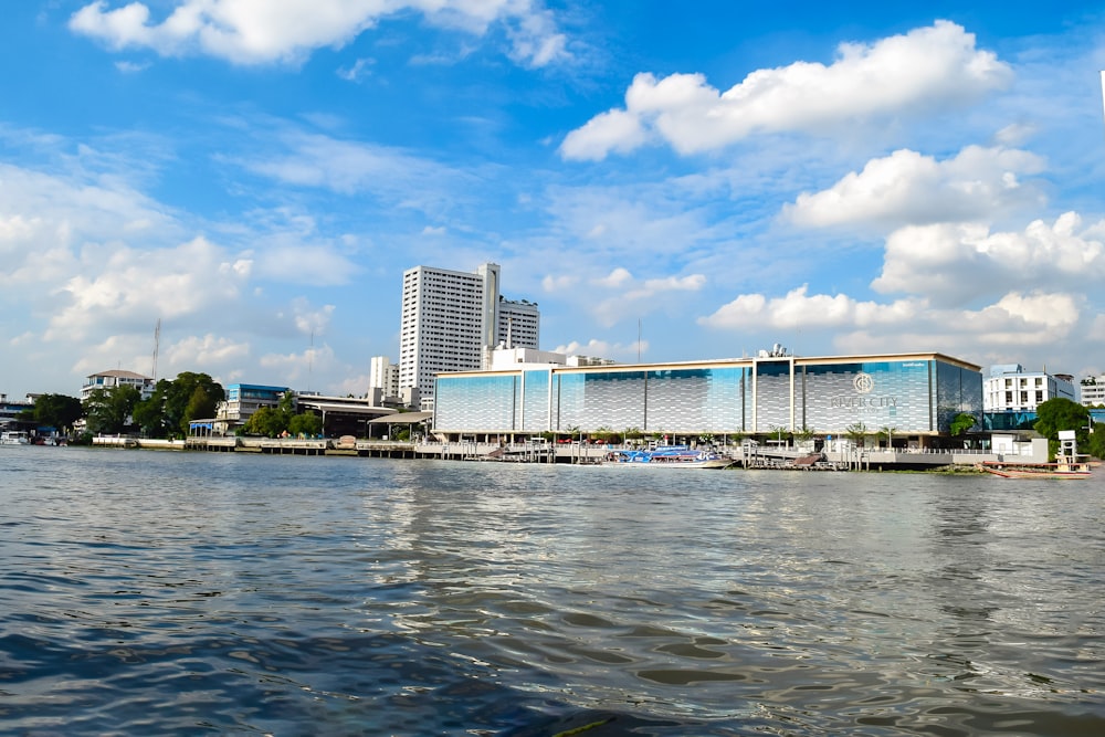 a body of water with buildings in the background