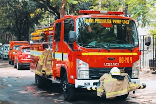 a group of fire trucks parked on the side of a road