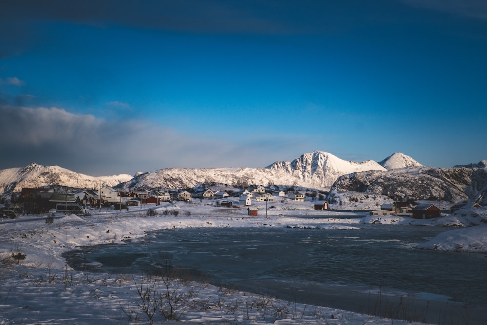 a snow covered landscape with mountains in the background