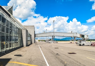 an airport terminal with a bridge over it