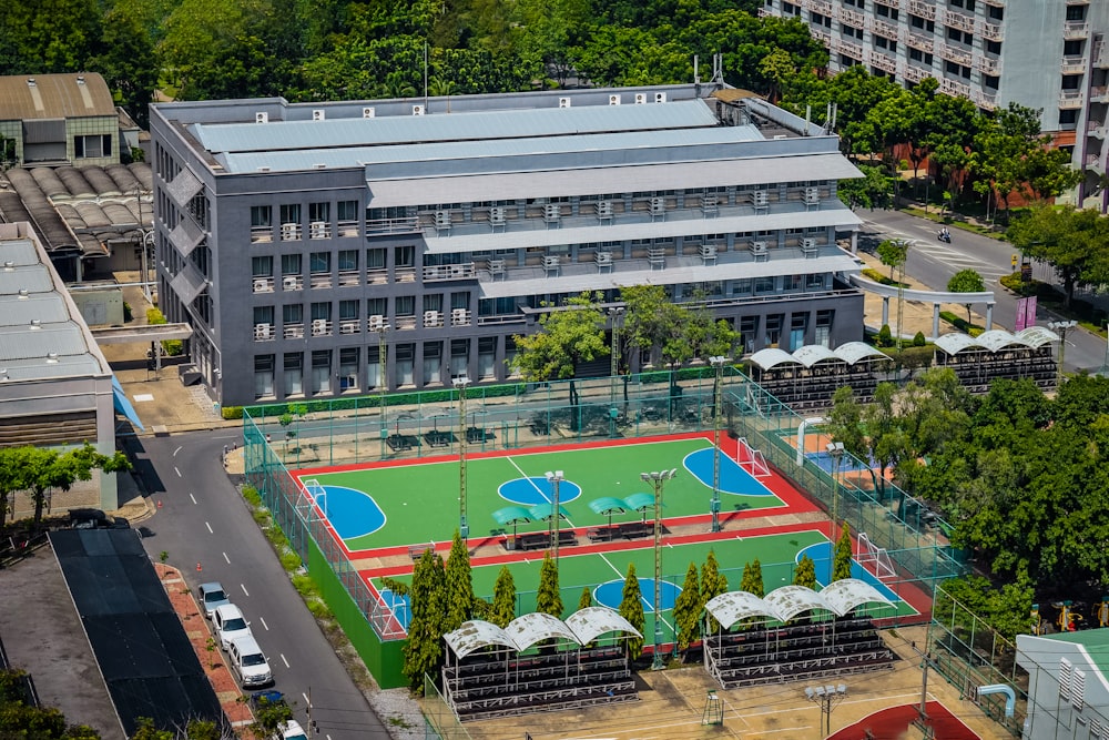 an aerial view of a tennis court in a city