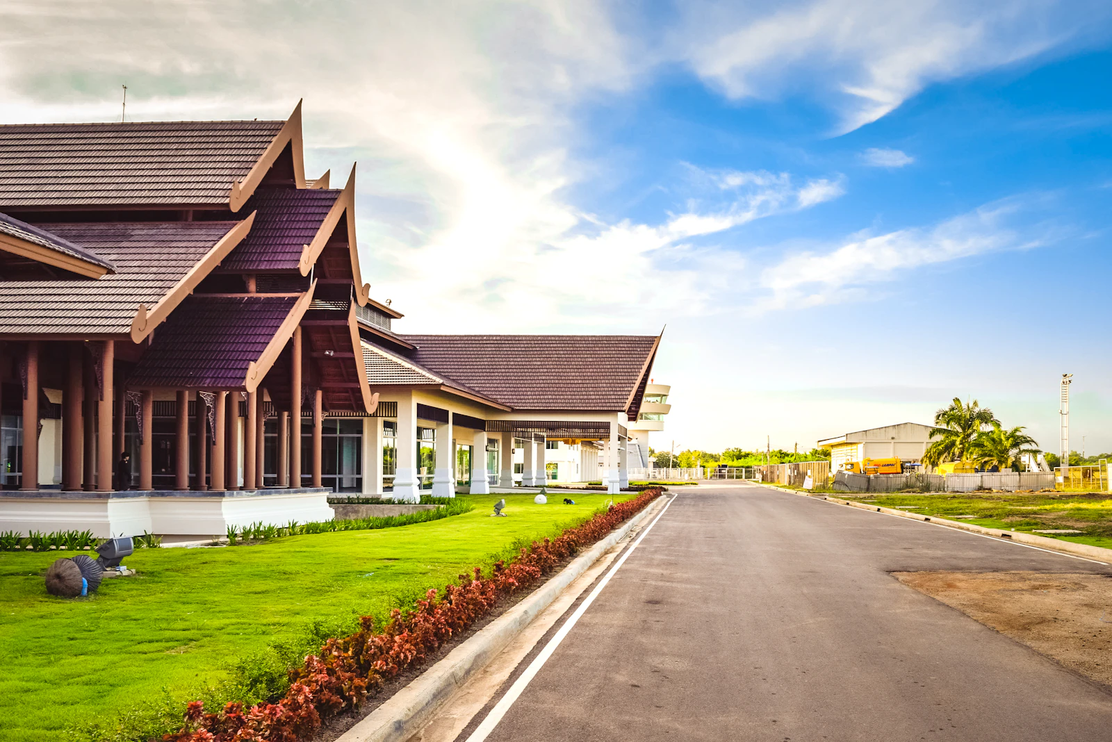 A quiet local road beside a traditional building in Thailand