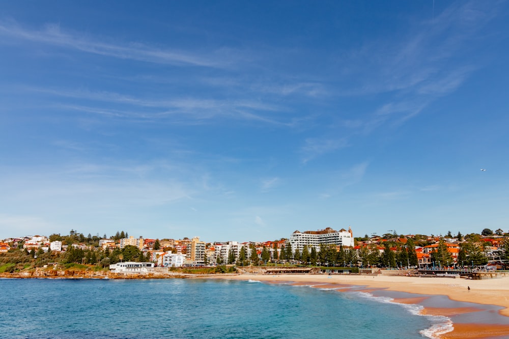 a view of a beach with buildings in the background