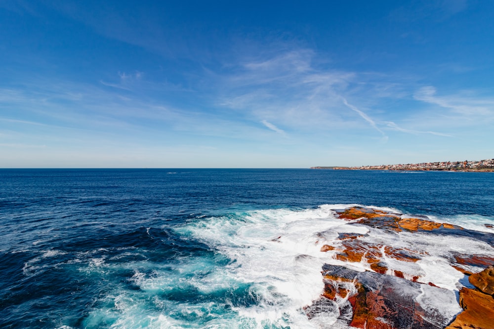 a view of the ocean from a rocky cliff