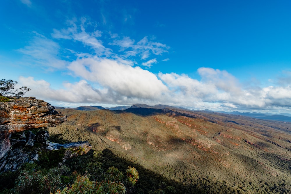 a view of a mountain range with clouds in the sky