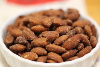 a white bowl filled with nuts on top of a table