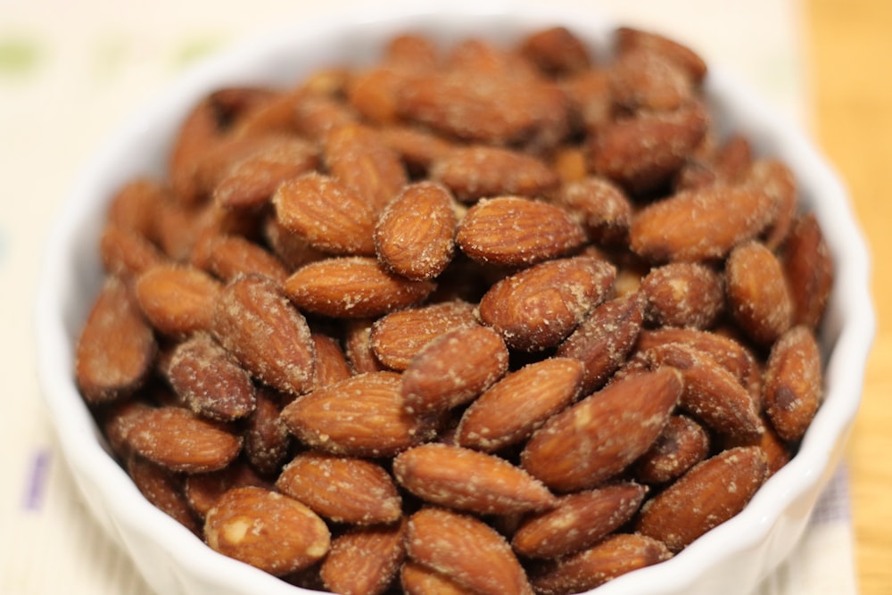 a white bowl filled with almonds on top of a table