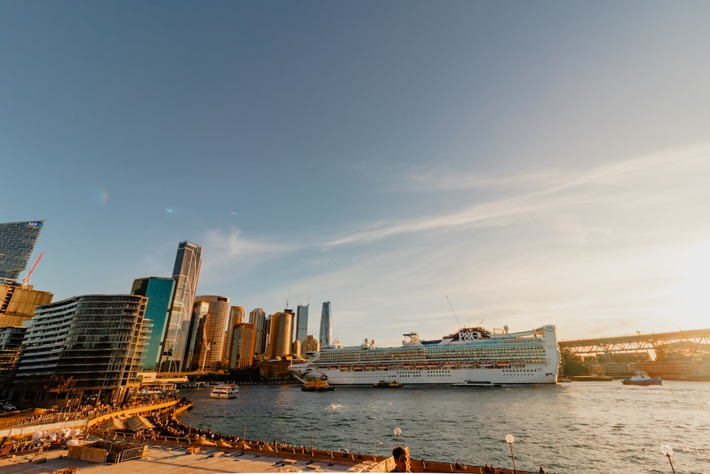 a cruise ship in the water near a city