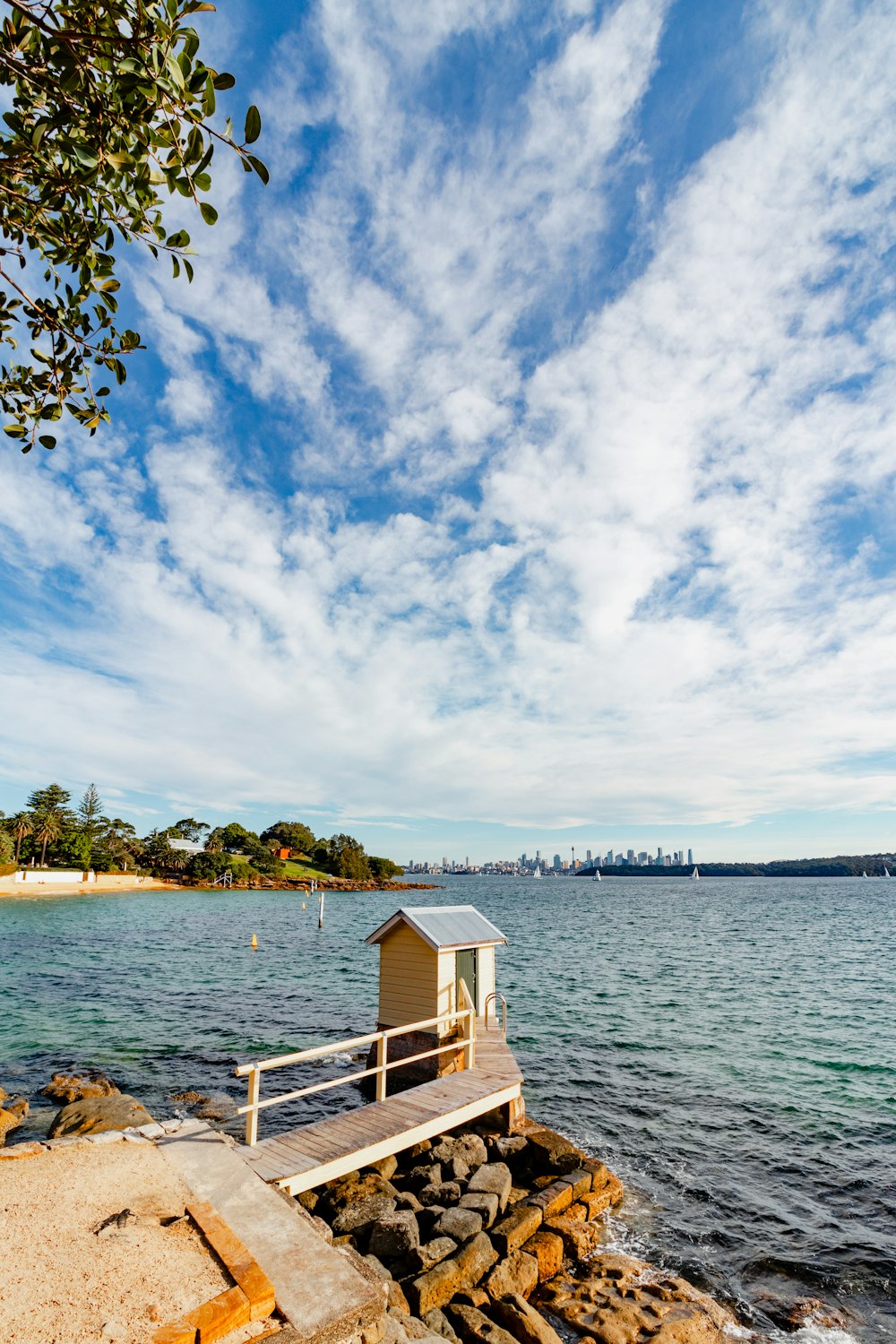 a small hut sitting on the edge of a body of water