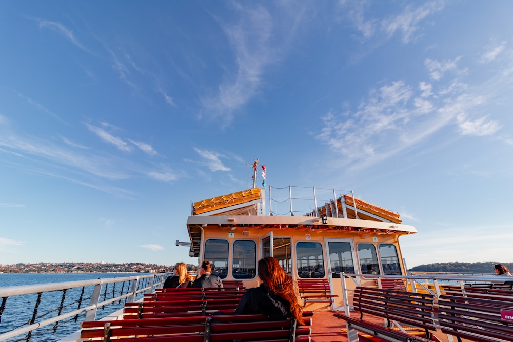 a couple of people sitting on a bench on a boat