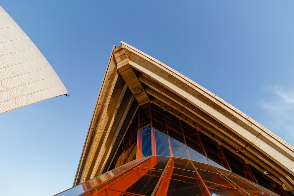 a tall building with a curved roof and a sky background