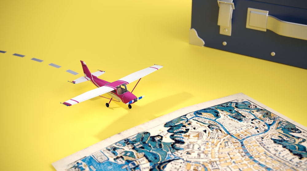 a toy airplane sitting on top of a map