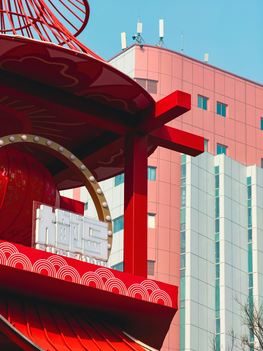 a large red structure with a clock on top of it