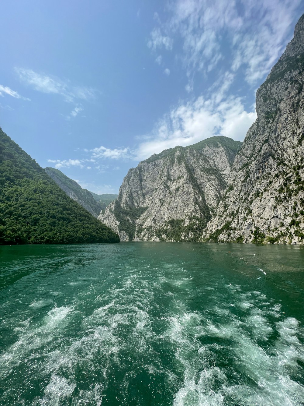 a body of water with mountains in the background