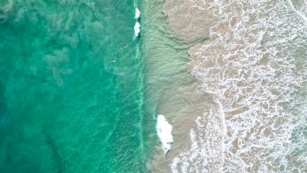an aerial view of the ocean and a beach