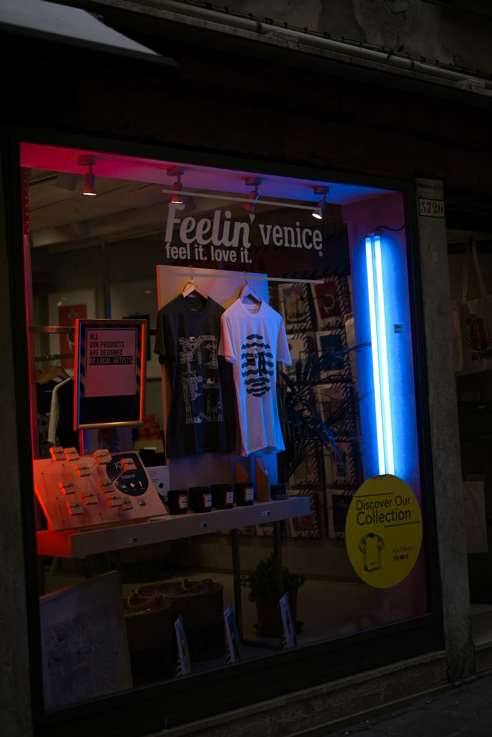 a store front window with a neon sign in the window