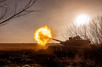 a tank that is on fire in a field