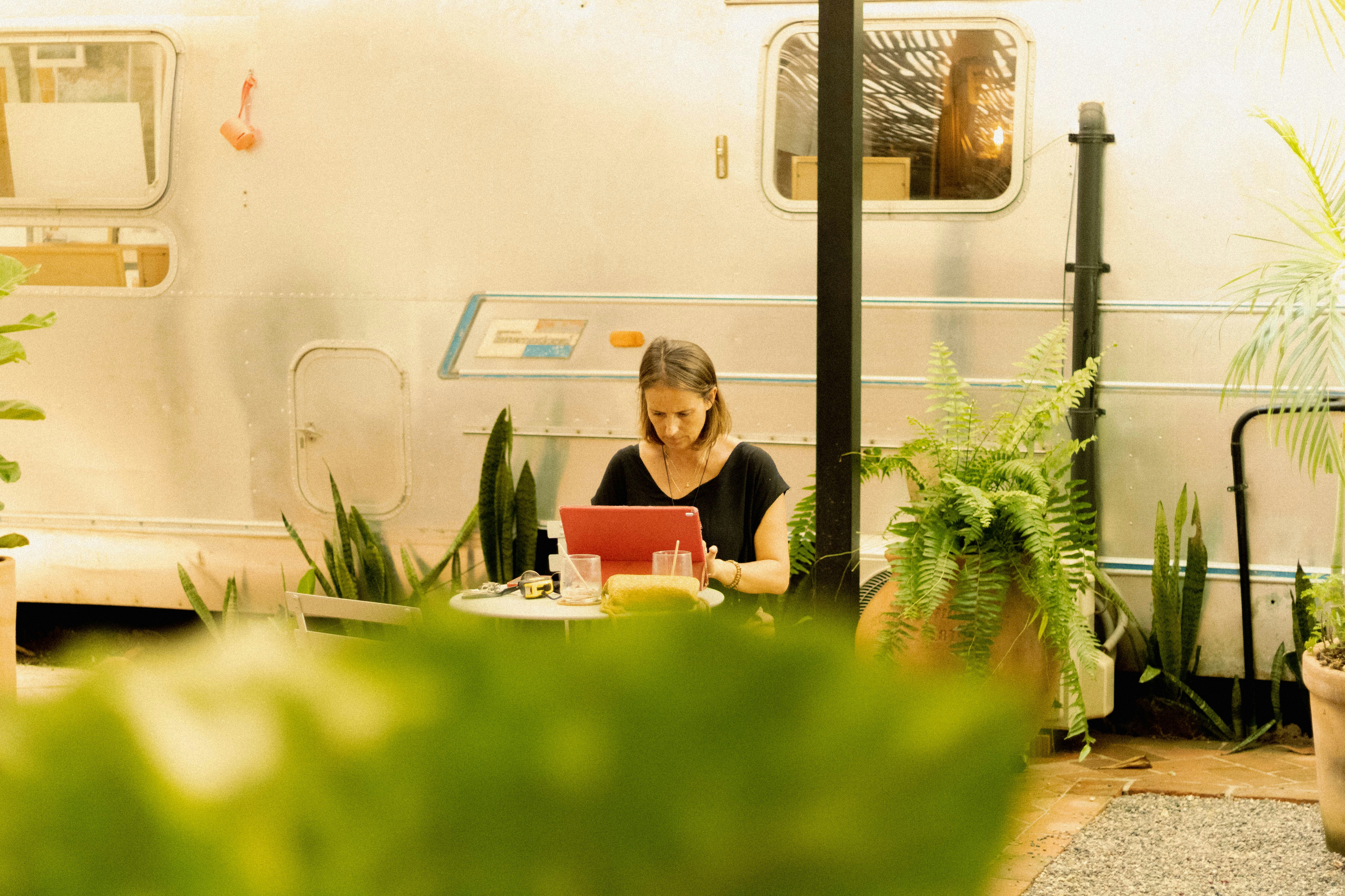 a woman sitting at a table with a laptop