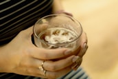 a close up of a person holding a drink