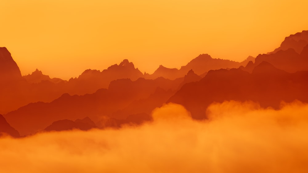 a view of a mountain range covered in fog