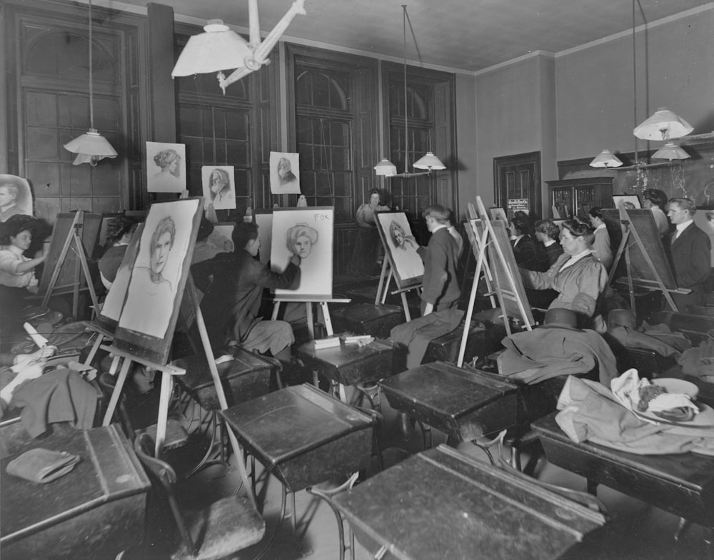 a group of people sitting in front of paintings