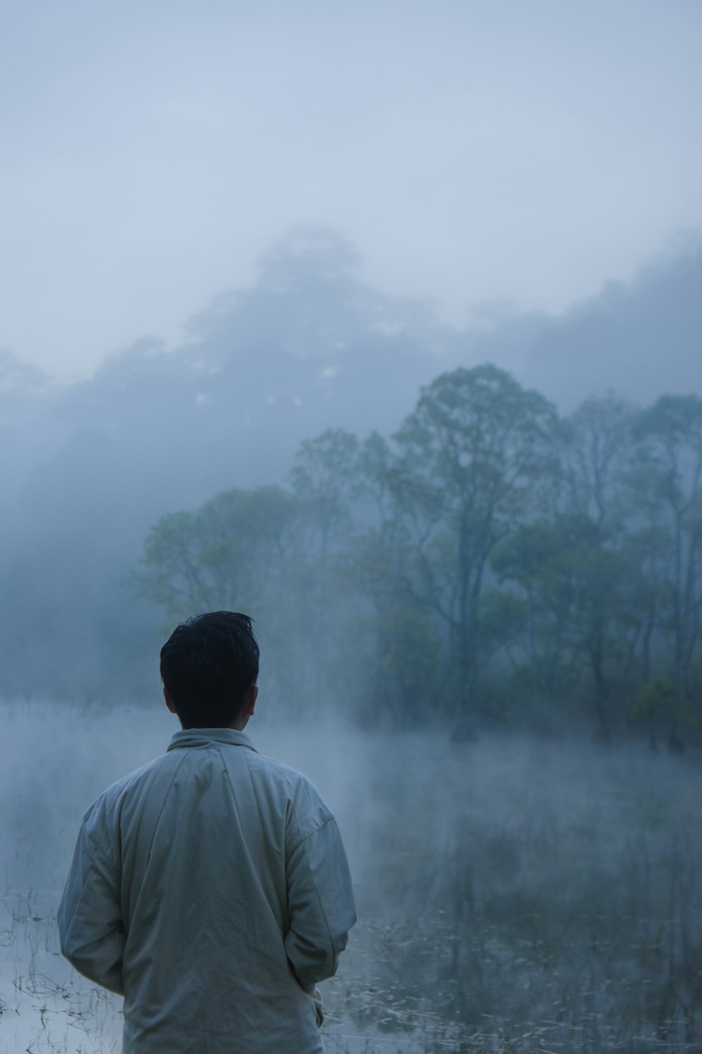 a man standing in front of a foggy field