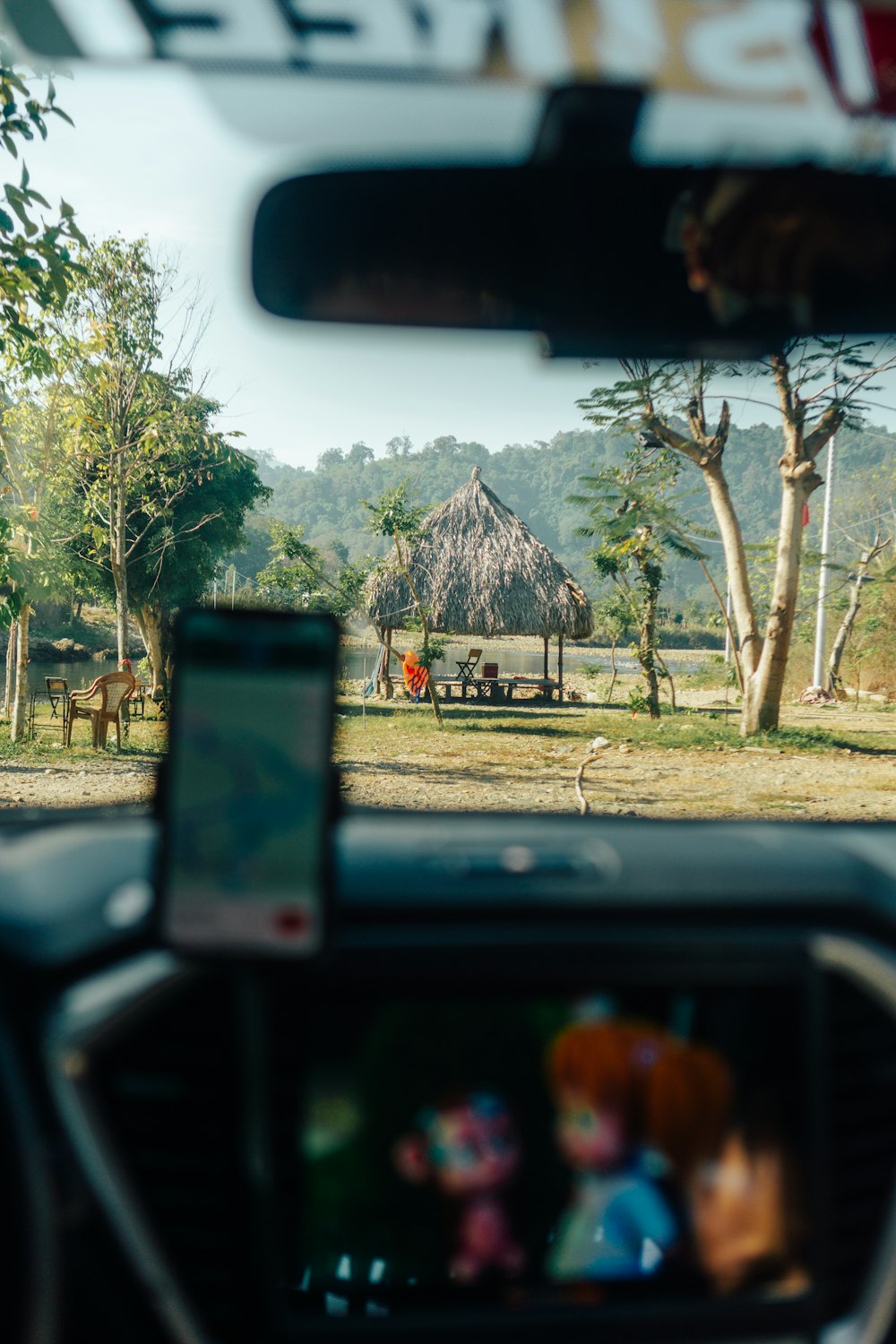 a view from inside a vehicle of a hut