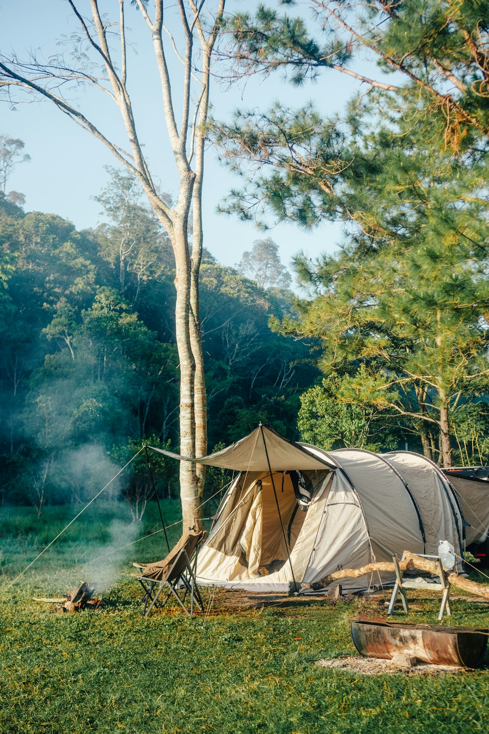 a tent set up in the middle of a forest